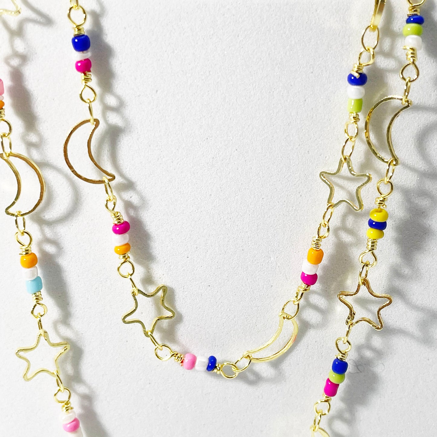 layering necklace enamel star moon close up